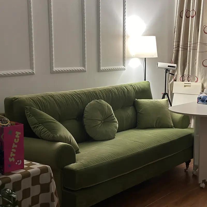 Green velvet sofa in a customer living room